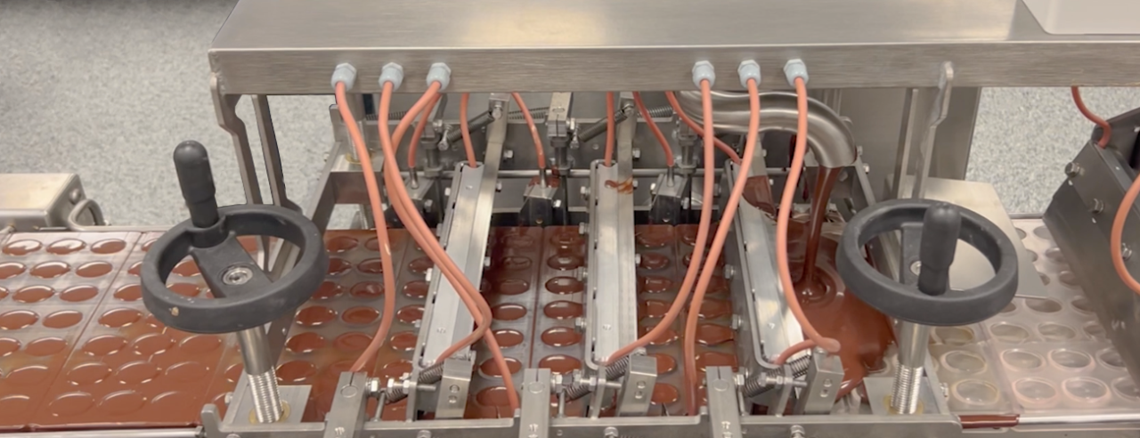 Overview of Betec's ML and CL series automated molding lines, featuring a range of options such as shape cooling tunnels and dosing machines, matching craftsmanship in chocolate production.